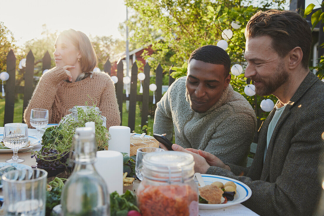 Friends having meal in garden