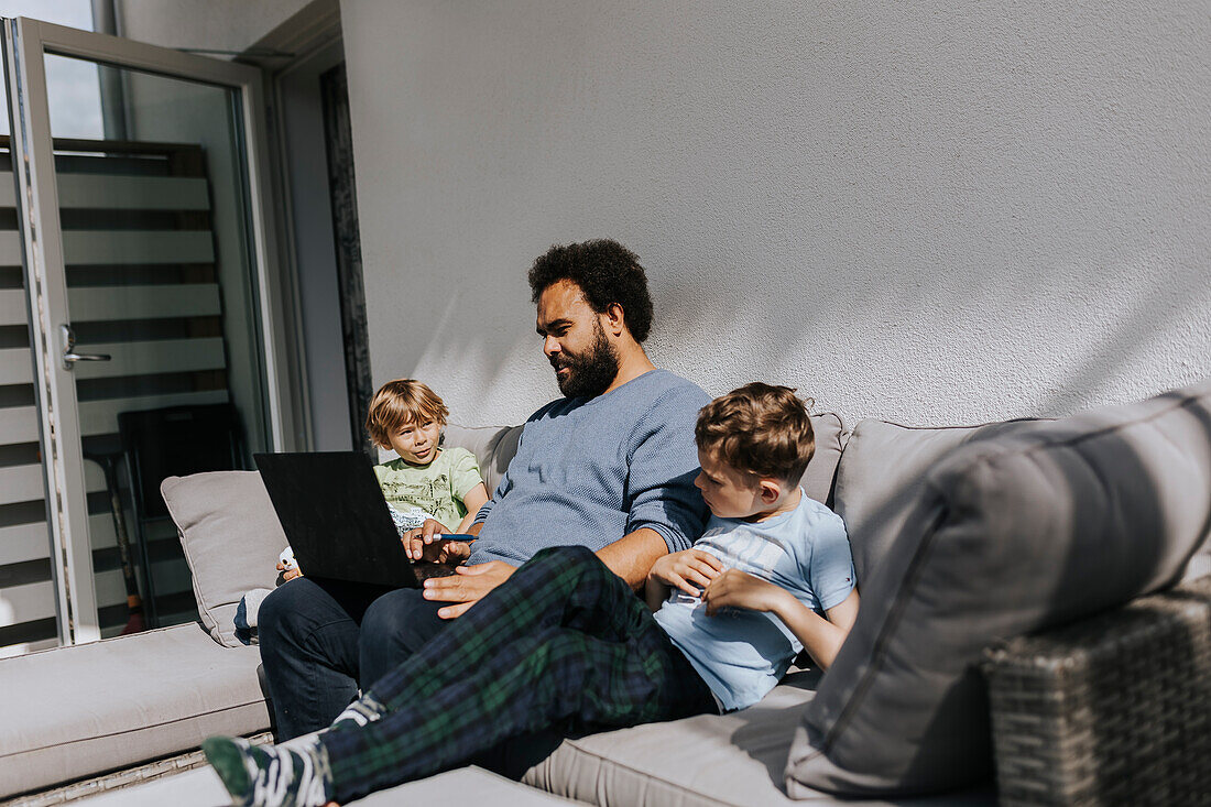 Man working from home and taking care of children