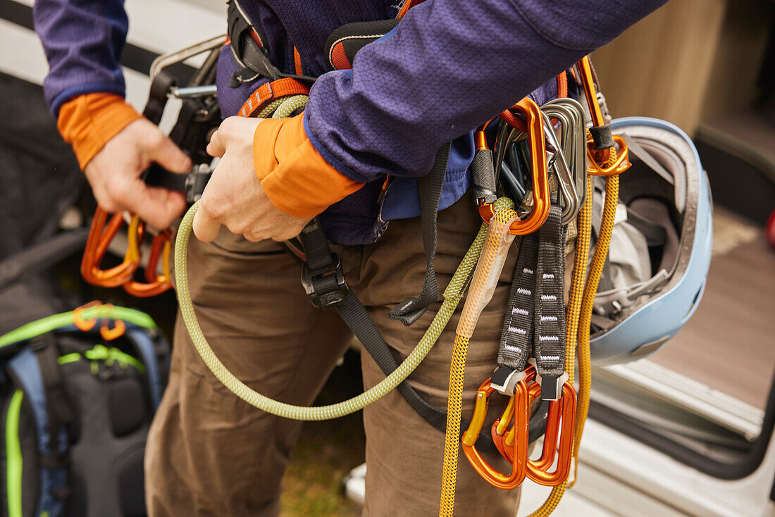 Rock climber putting gear on