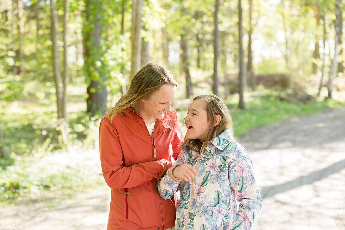 Mother with daughter standing together