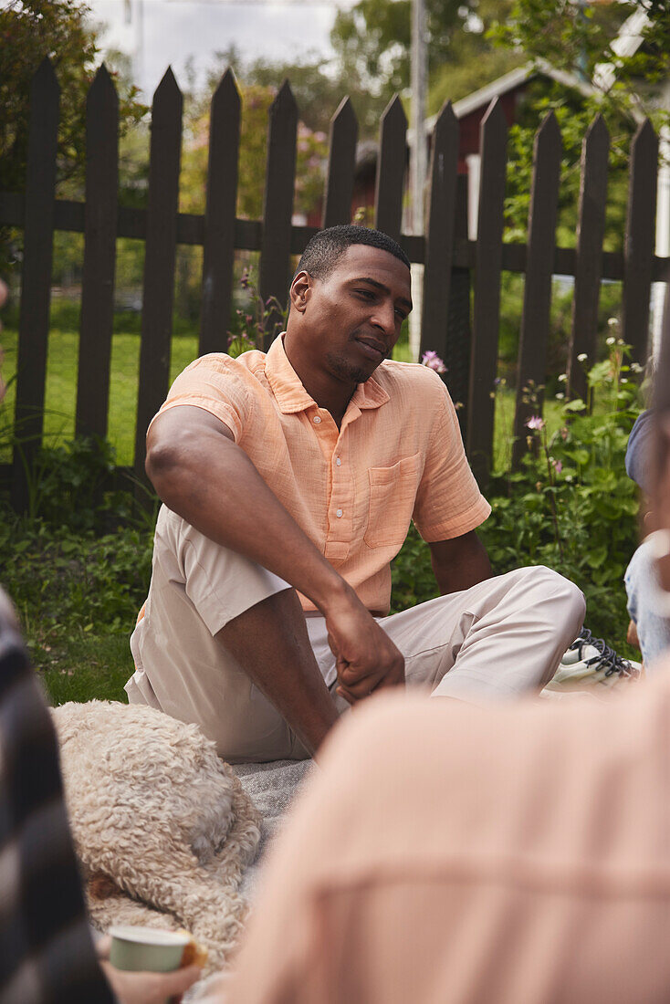 Smiling man sitting in garden