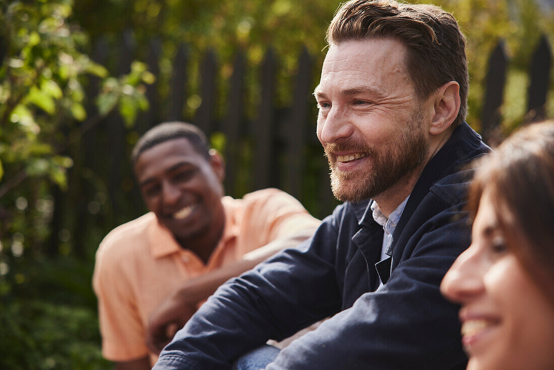 Smiling man sitting in garden