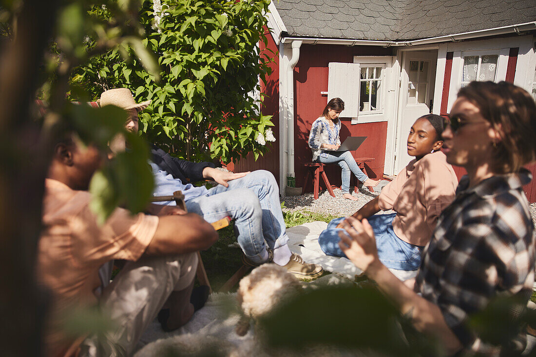 Friends sitting together in garden