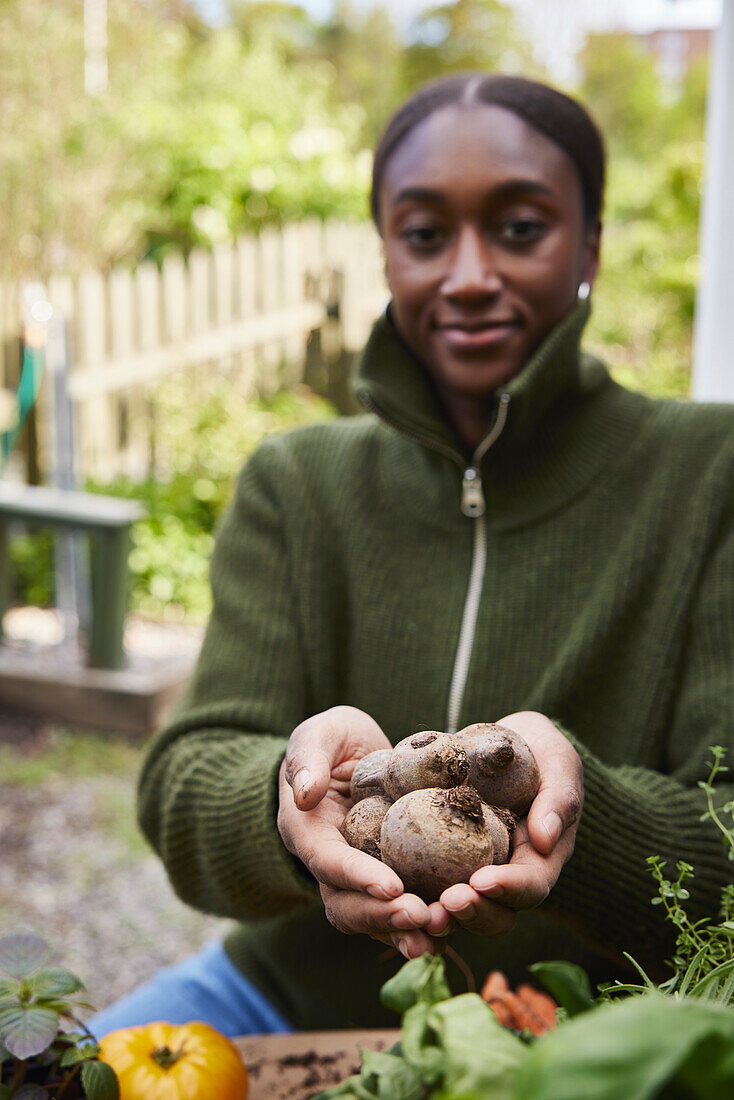 Woman holding homegrown beetroots