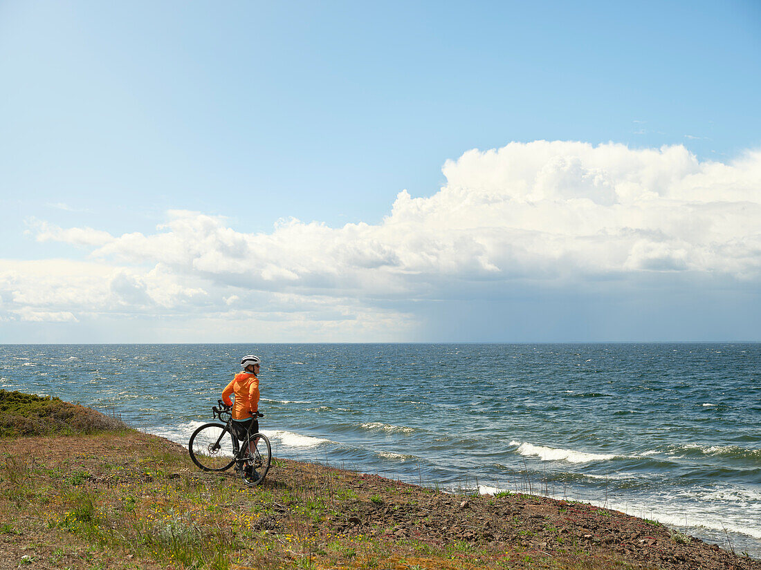 Cyclist looking at sea