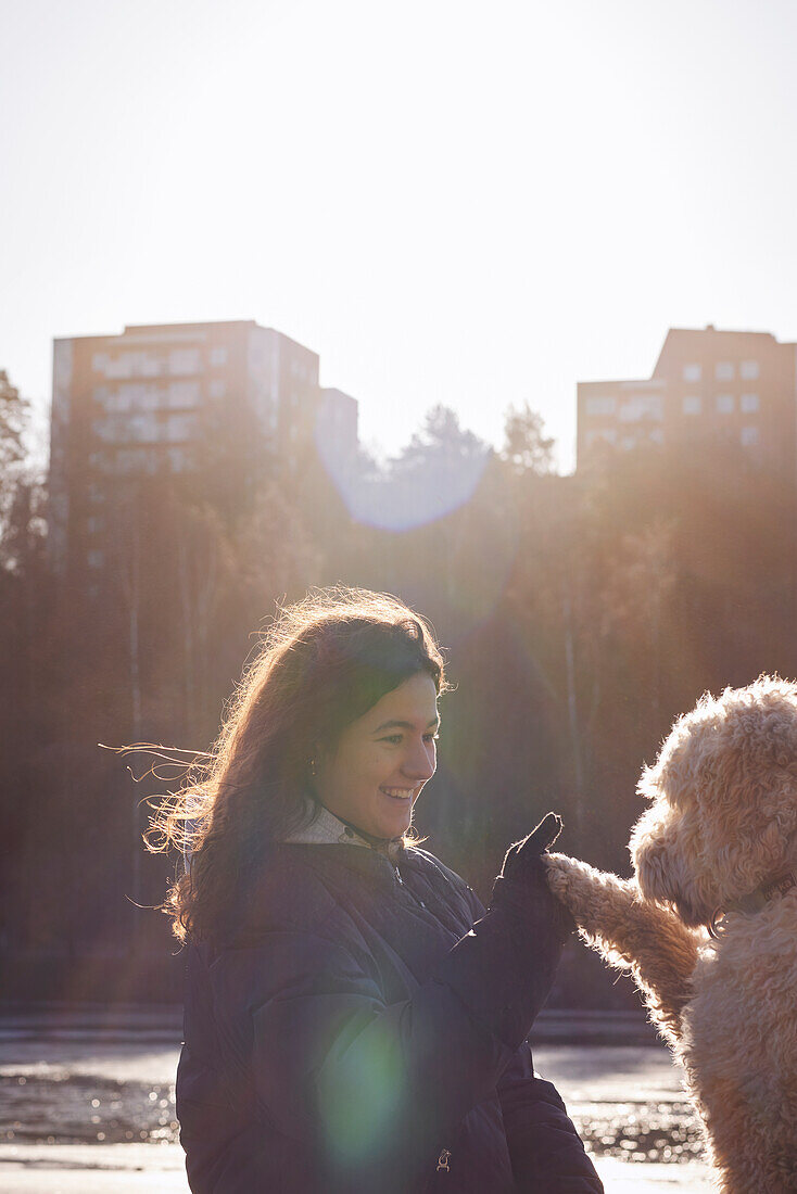 Woman giving high five to dog