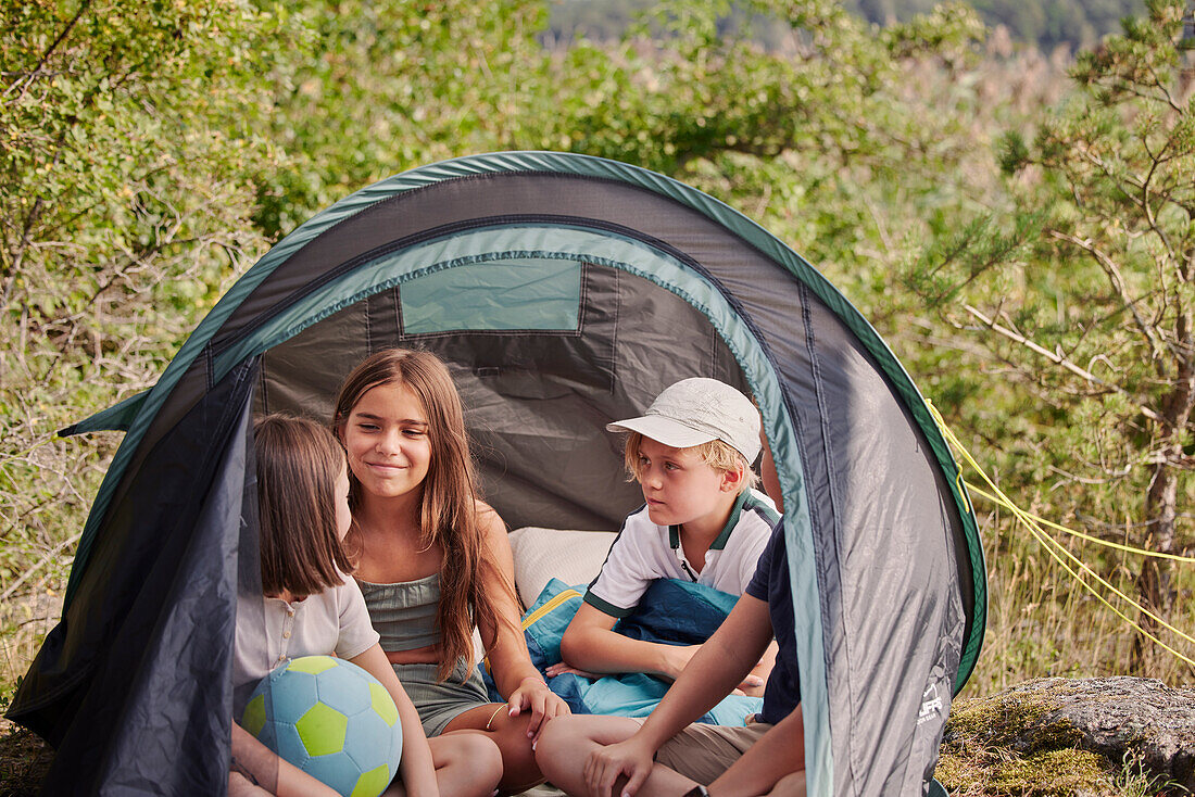 Children sitting in tent