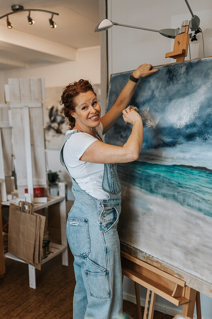 Artist painting in studio