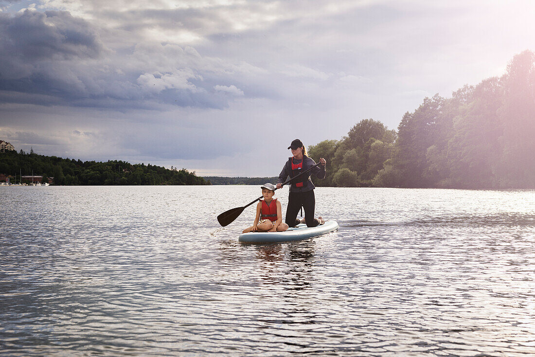 Mother and son paddle boarding