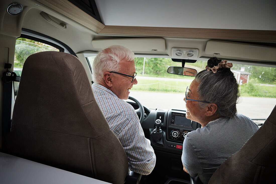 Senior couple traveling by van