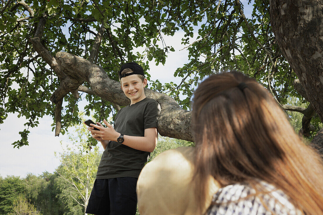 Smiling boy using cell phone