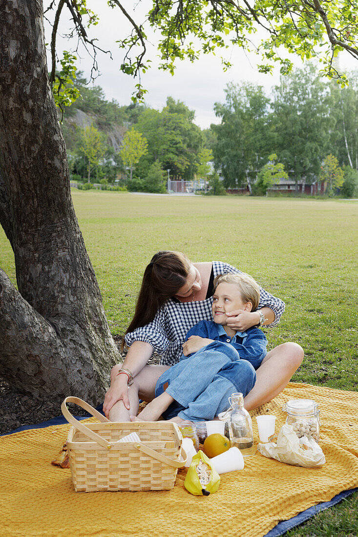 Mother and daughter having picnic