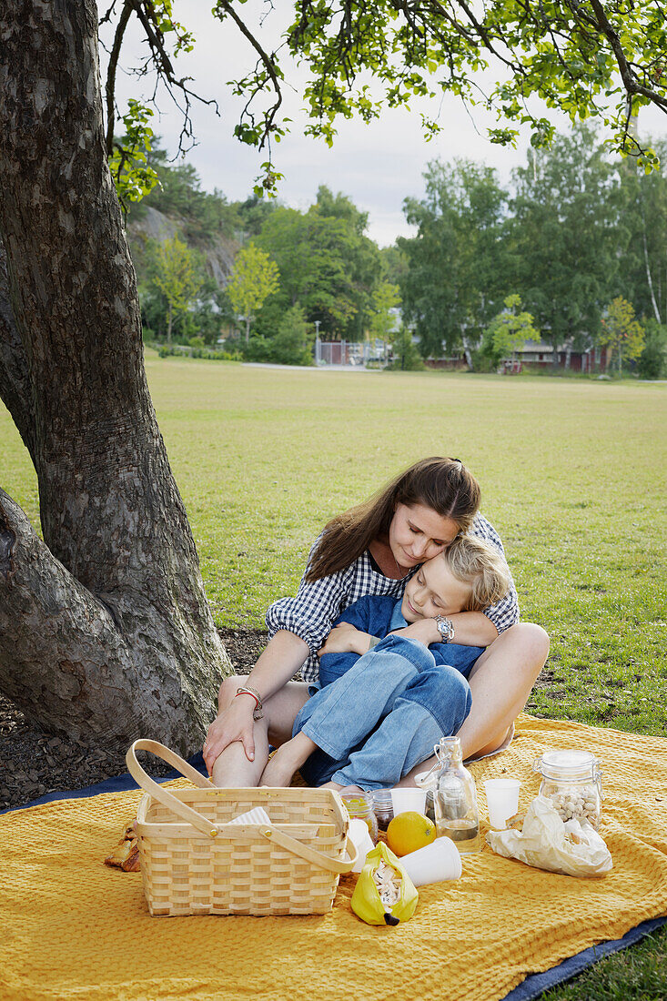 Mother and daughter having picnic