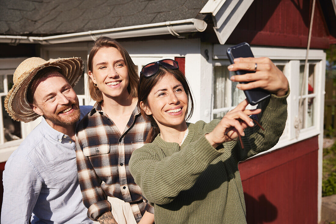 Smiling friends taking selfie