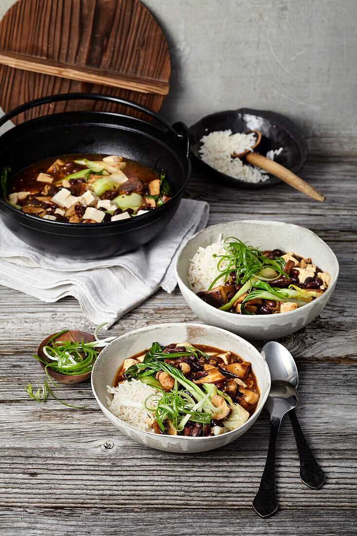 Vegan mapo tofu with chopped shiitake mushrooms, rice and Szechuan pepper