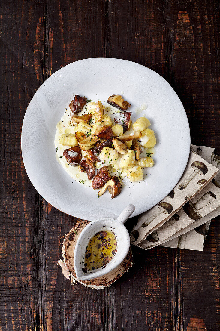 Porcini gnocchi with creamy cheese sauce and coffee oil