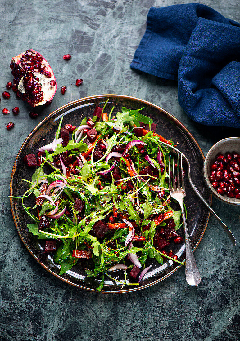 Arugula and beet salad with roasted carrots and pomegranate seeds