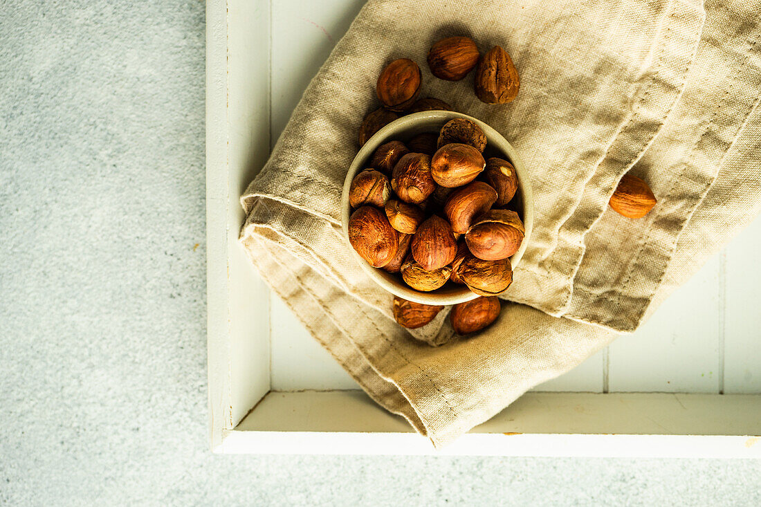 Bowl with organic hazelnuts on the napkin