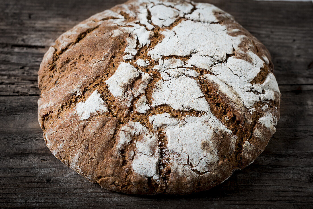 Loaf of bread on wooden background