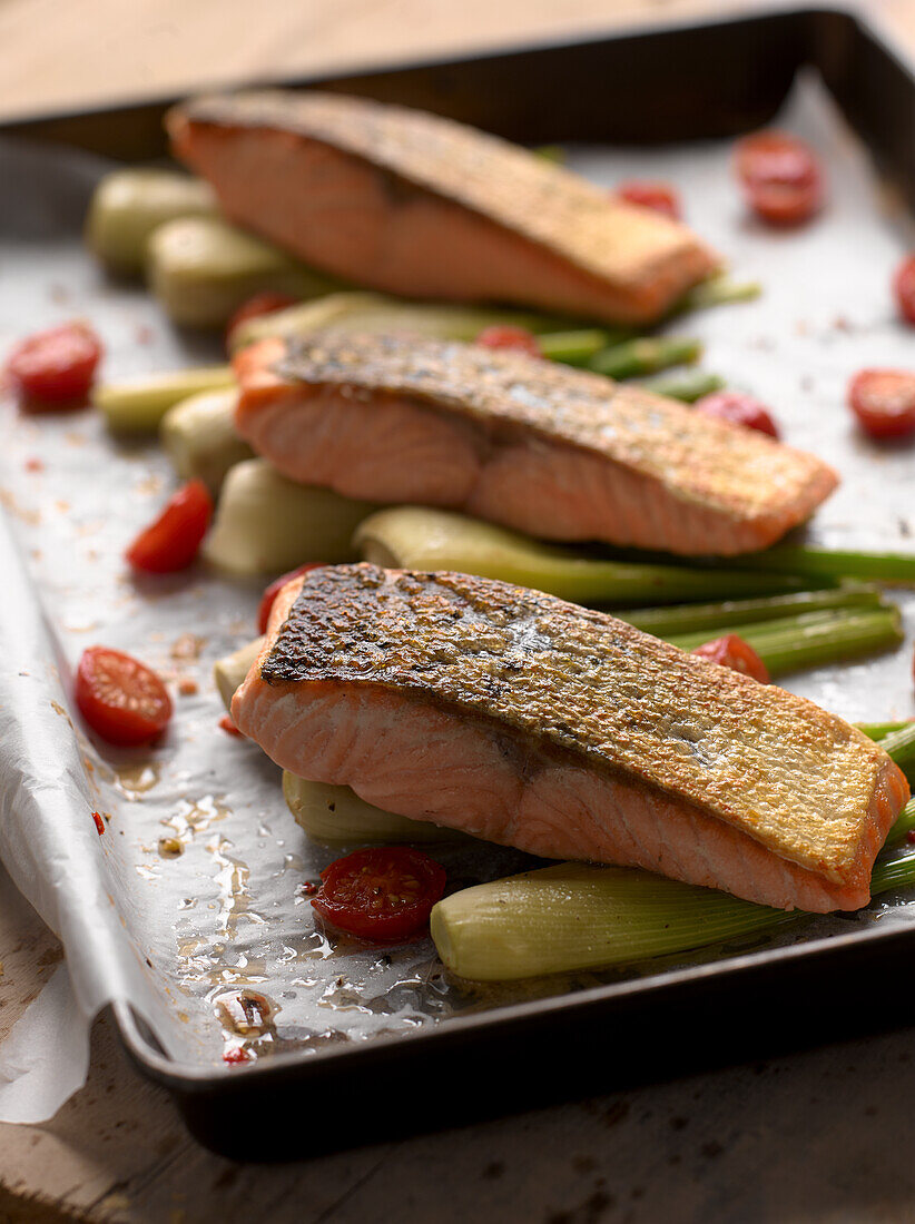 Roasted salmon on mini fennel with tomatoes