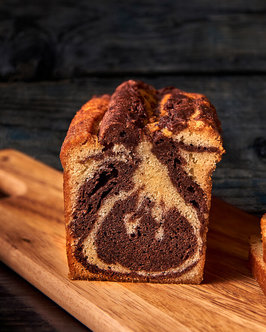 Marble loaf cake, cut on a wooden board