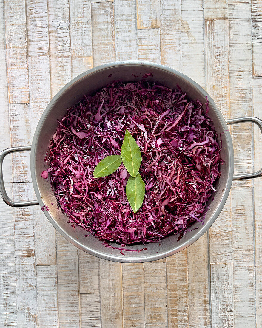 Shredded red cabbage with laurel in a pot