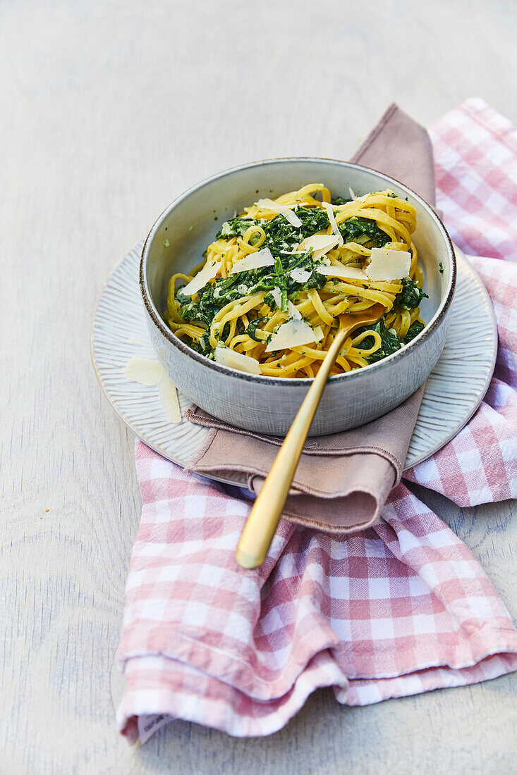 Tagliatelle with spinach sauce and fresh shredded parmesan
