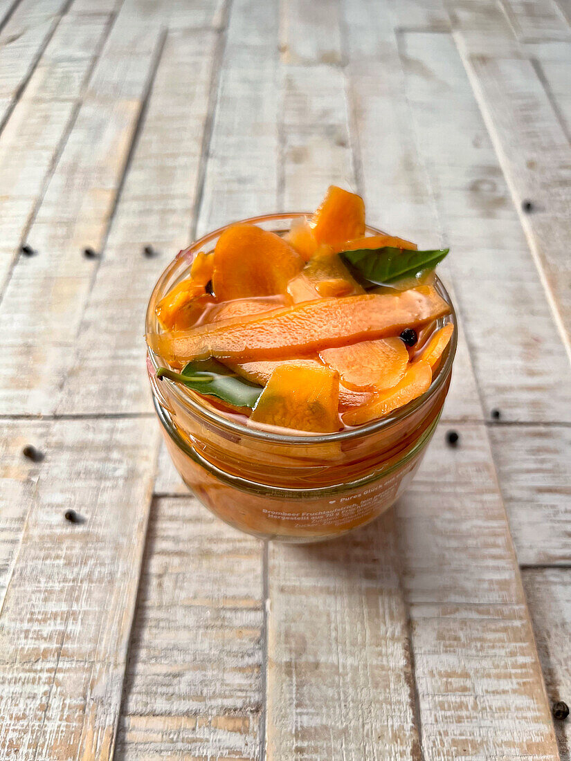 Homemade pickled carrot strips with bay leaf