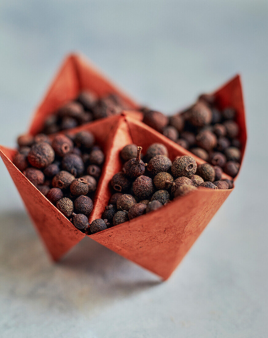 Allspice berries in origami paper bowls