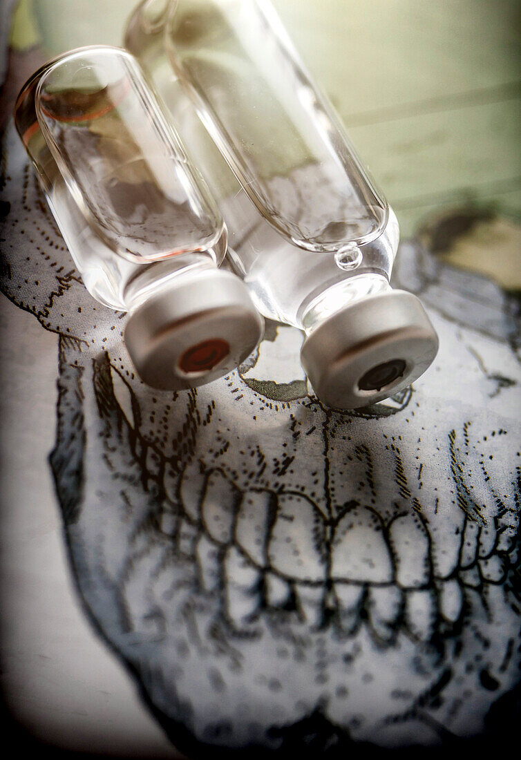 Vials on a skull, conceptual image