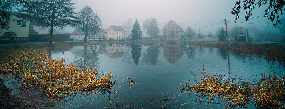 Village reflected in pond
