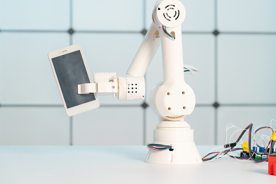 Robotic arm holding mobile phone