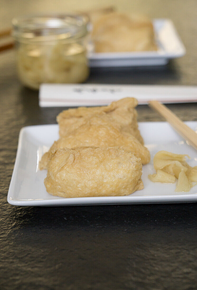 Inari Sushi (deep-fried tofu pockets filled with rice) with gari (ginger)