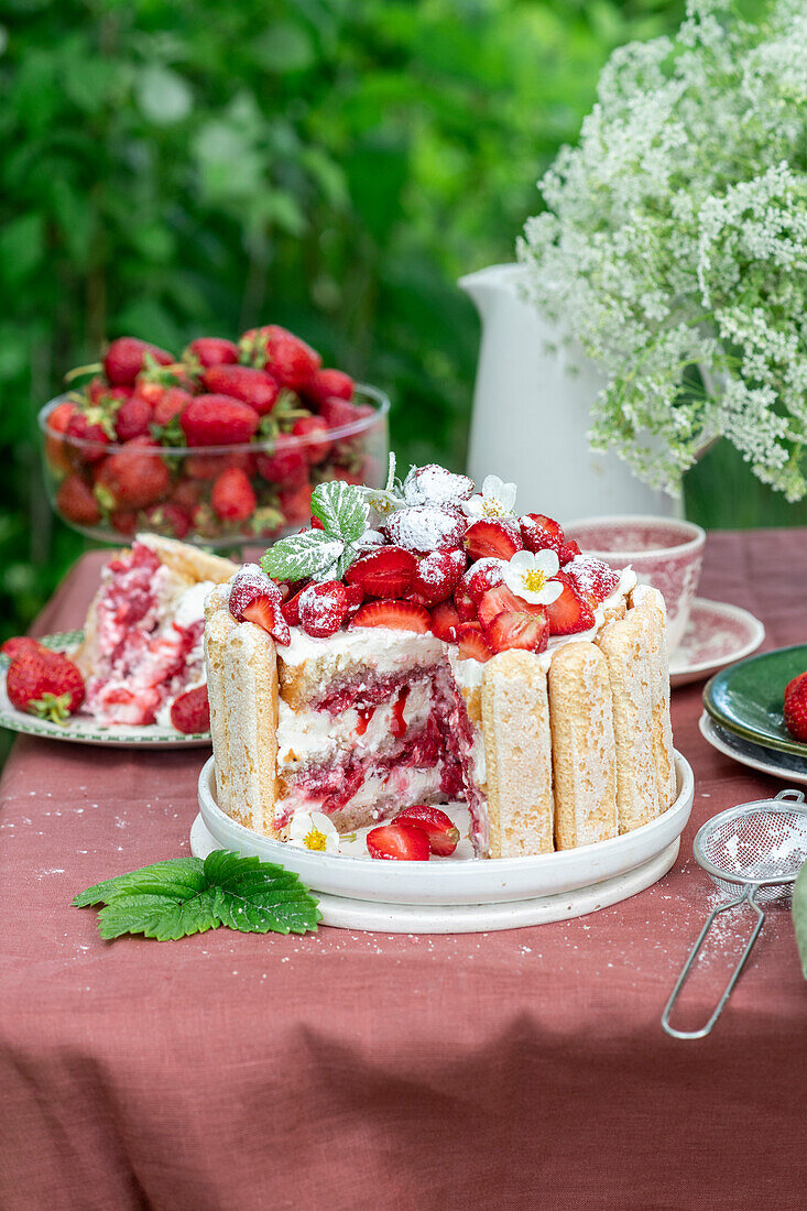Erdbeer-Tiramisu-Torte auf Tisch im Freien