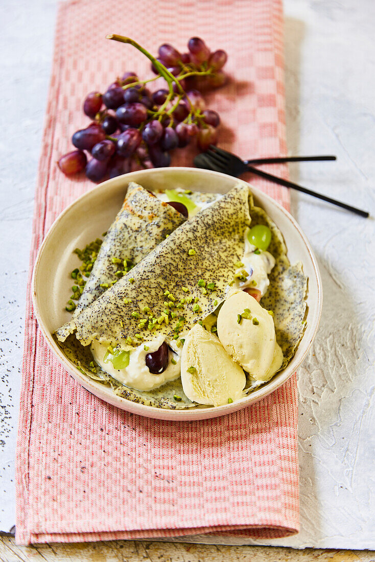 Poppy seed pancakes with grapes and ice cream