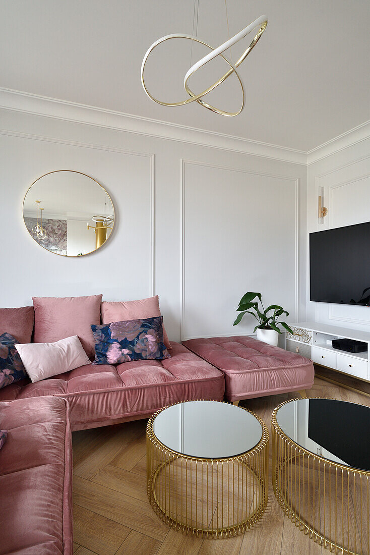 Comfortable pink velvet sofa with coffee table set in bright living room