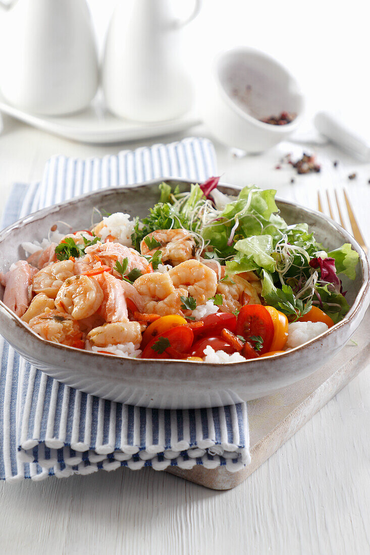 Dish with shrimps, salmon, rice and vegetables