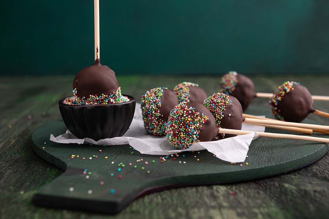 Vegan vanilla cake pops with plain icing and sugar sprinkles