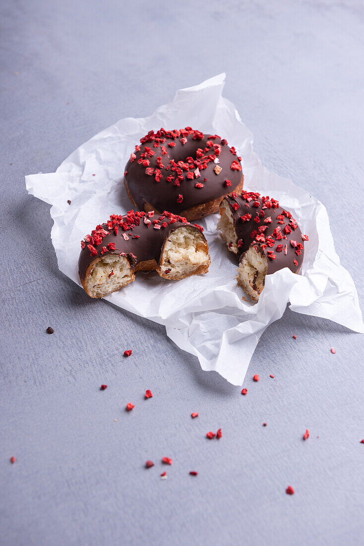 Chocolate dipped donuts topped with freeze-dried strawberries