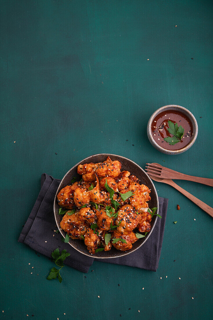 Spicy cauliflower buffalo bites with sesame seeds