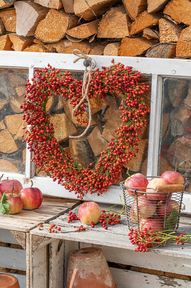 Rosehip heart hung on old window frame