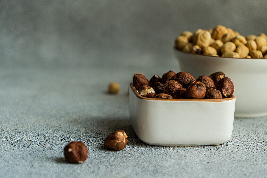 Bowl full of hazelnuts on concrete background