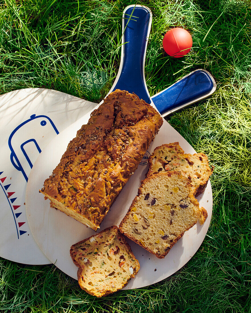 Loaf carrot cake on ping pong paddles in the grass