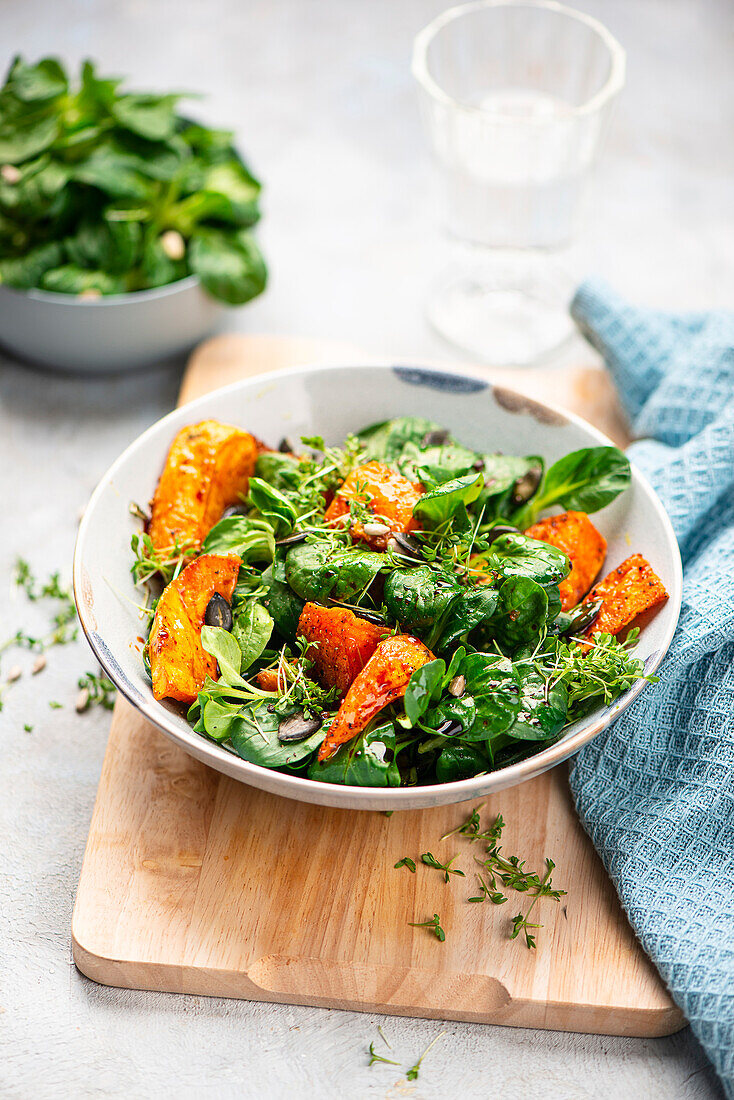 Lamb's lettuce with roasted sweet potatoes, pumpkin and cress