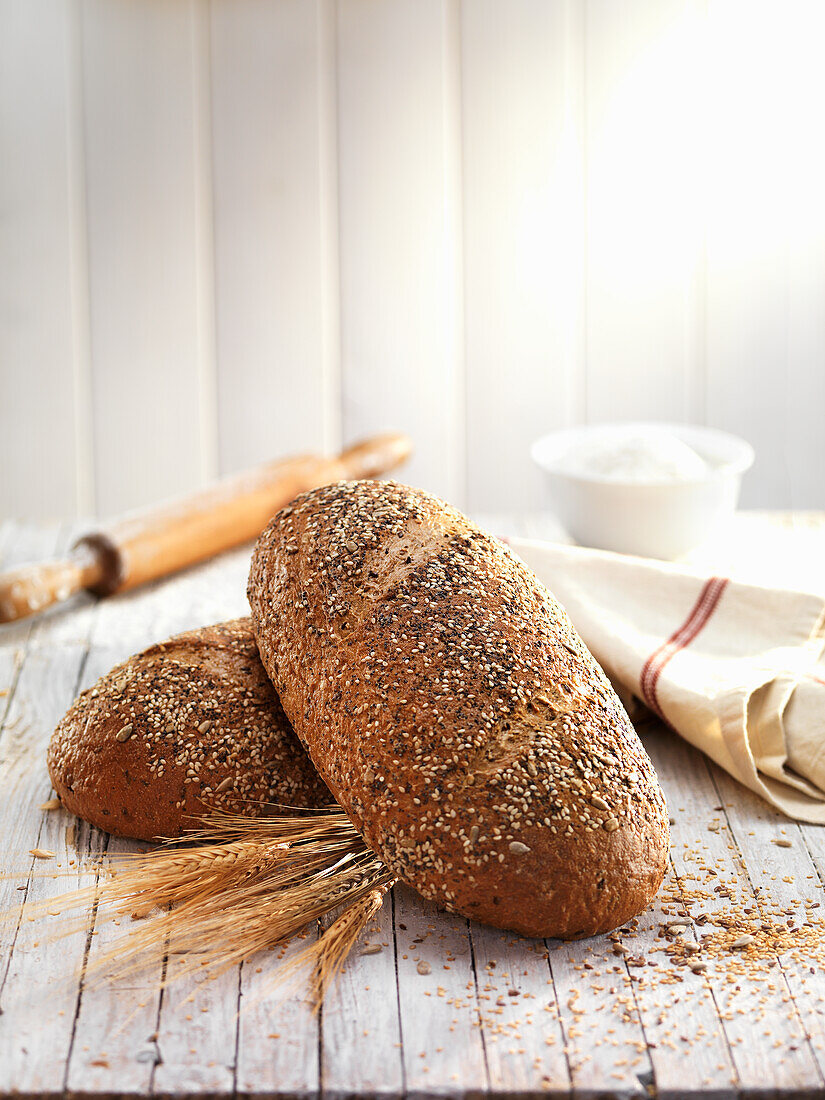 Loaves of wheat bread topped with mixed seeds