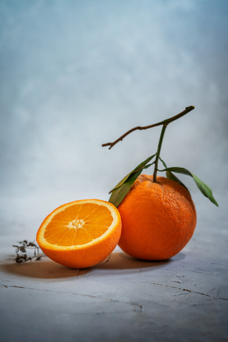 Orange half and whole orange with leaves