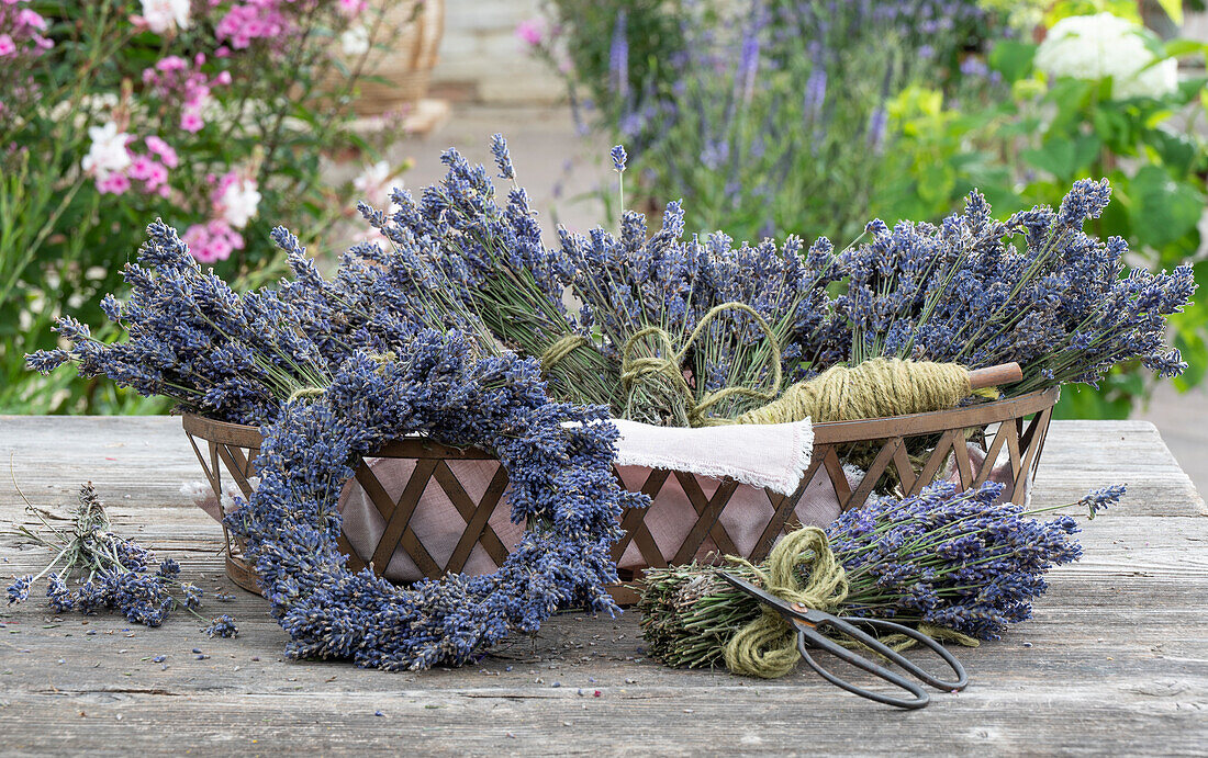 Lavender wreath and bouquet in basket on wooden table