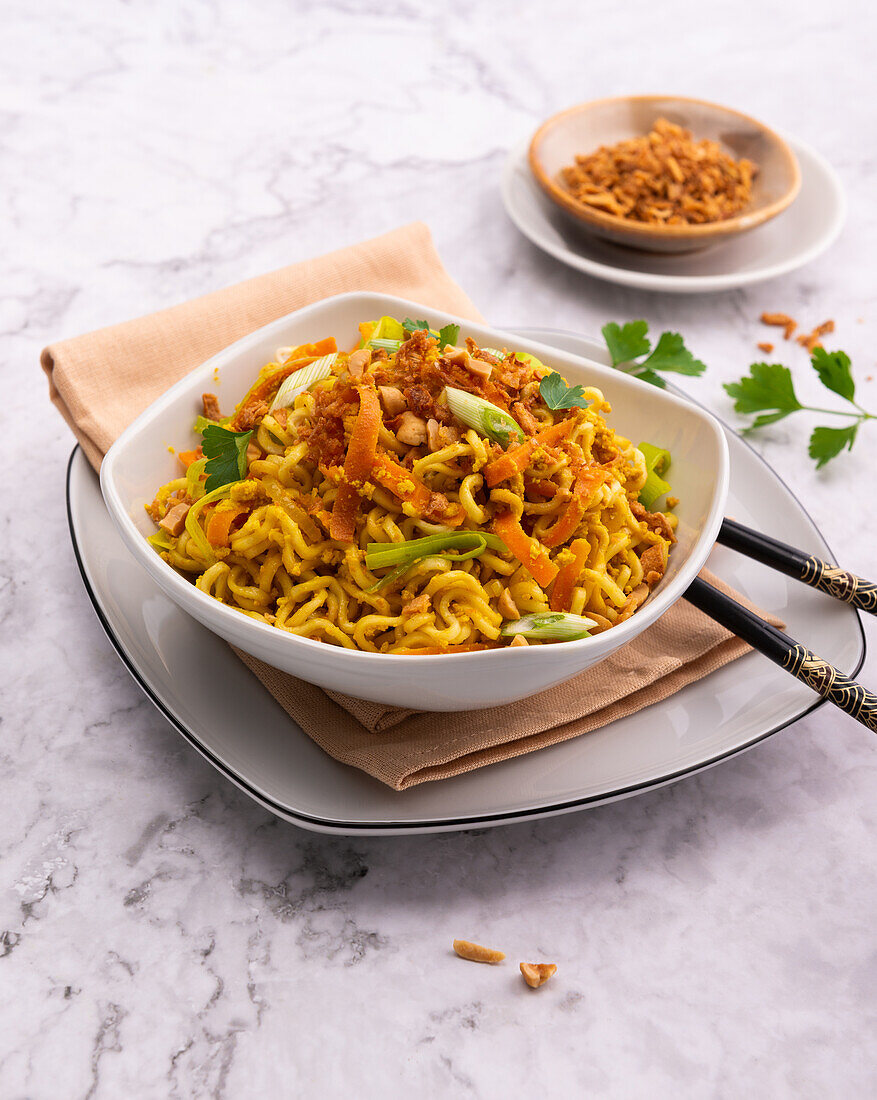 Fried Mie noodles with vegetables, scrambled tofu and peanuts