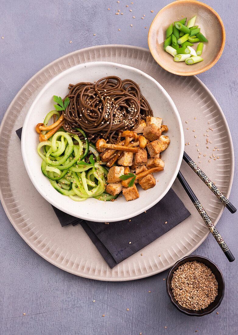 Soba noodles with tofu, shimeji mushrooms, cucumber salad and roasted sesame seeds