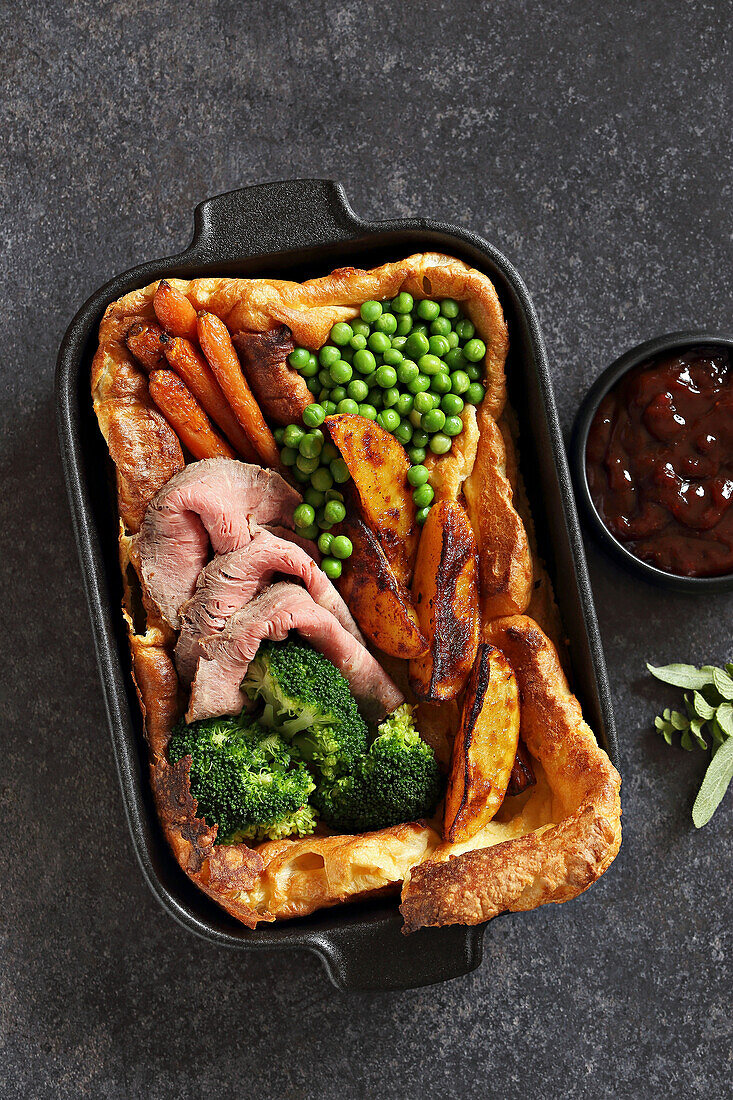 Giant Yorkshire pudding with roastbeef, roasted potato, broccoli and young carrots